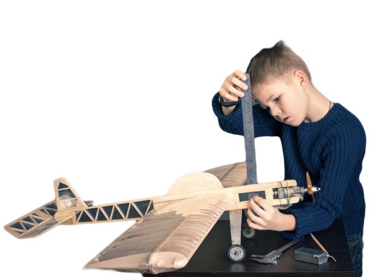 Boy building model airplane